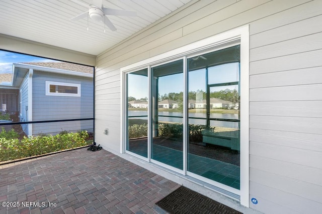 exterior space with ceiling fan and a water view