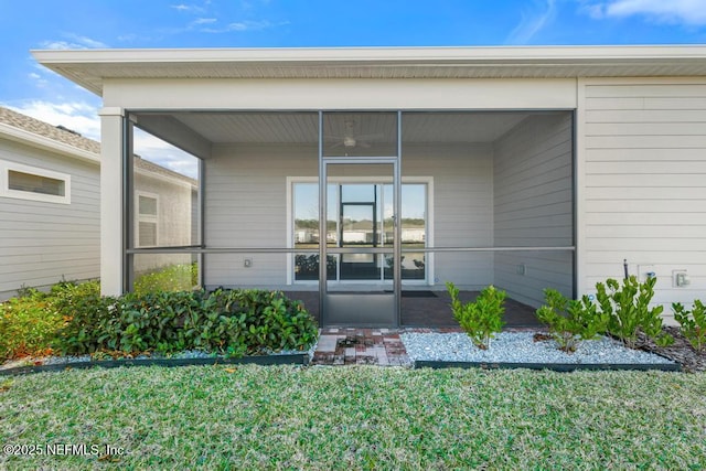 entrance to property featuring a lawn