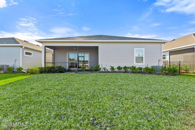 rear view of property with a yard and central AC unit