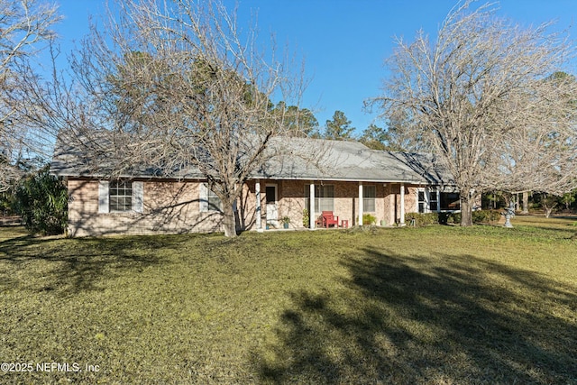 back of property with a lawn