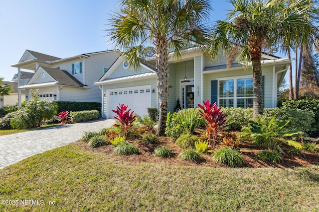 view of front of house featuring a garage and a front lawn