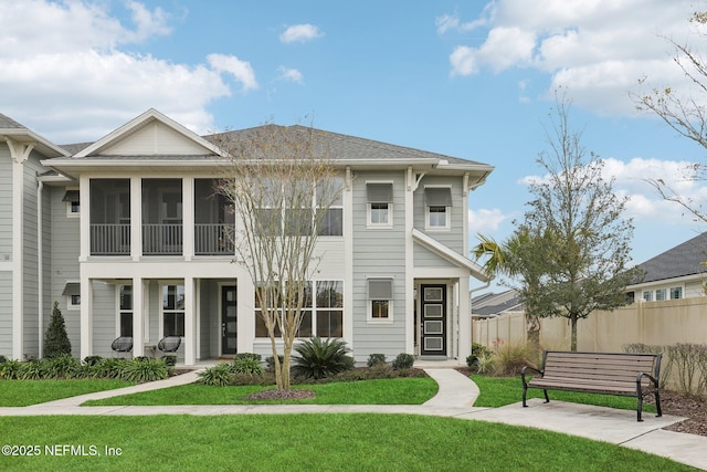 view of front facade featuring a front lawn and a sunroom