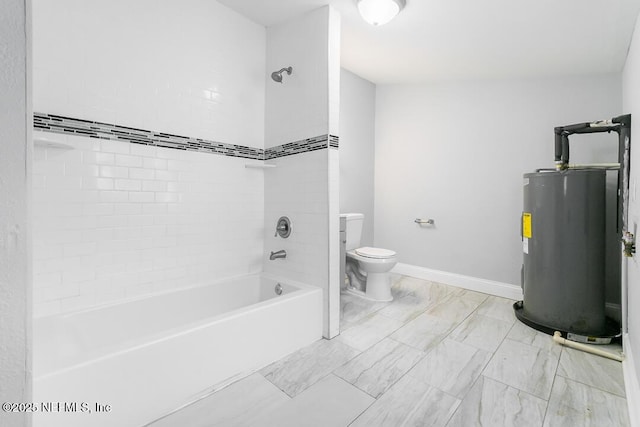 bathroom featuring toilet, water heater, and tiled shower / bath