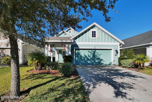 view of front of property featuring a garage and a front lawn