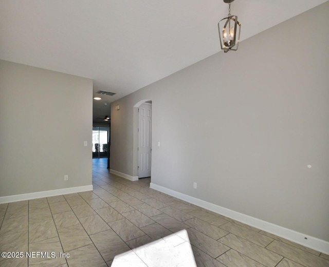 spare room with an inviting chandelier