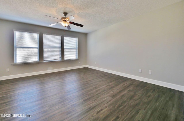 empty room with ceiling fan, a textured ceiling, and dark hardwood / wood-style floors