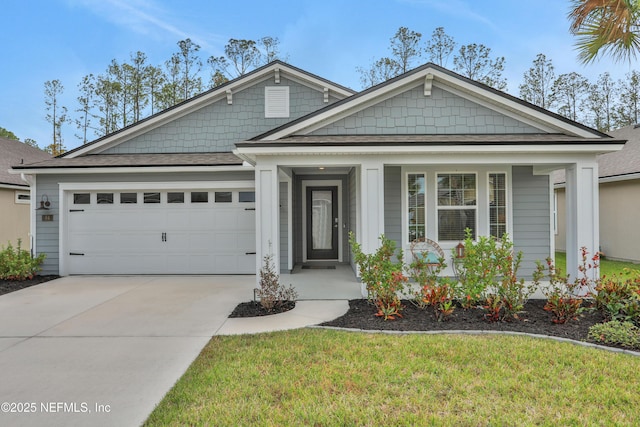 view of front of house with a front lawn, covered porch, and a garage