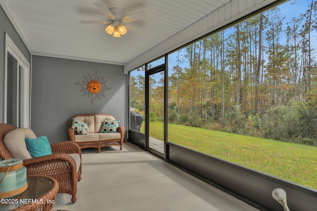 sunroom / solarium featuring ceiling fan