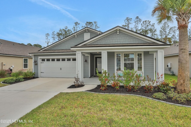 view of front facade featuring covered porch, a front yard, and a garage