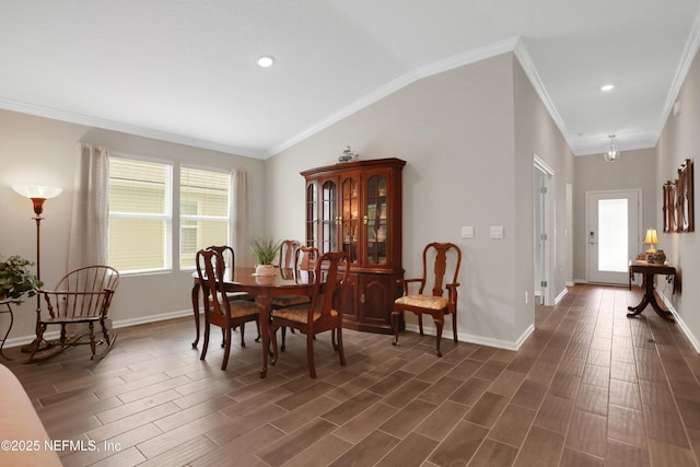 dining space with lofted ceiling, crown molding, and a healthy amount of sunlight