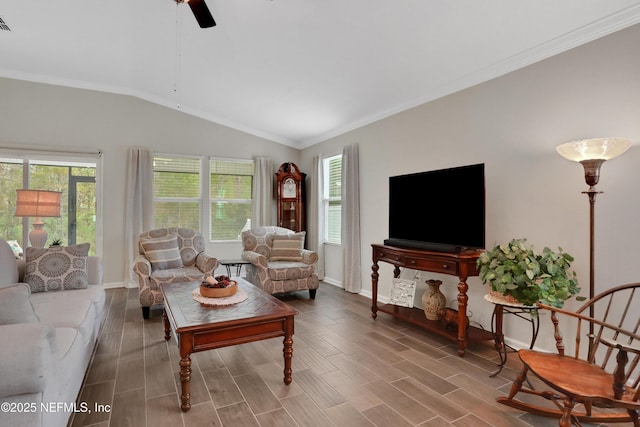 living room with a healthy amount of sunlight, vaulted ceiling, and ornamental molding