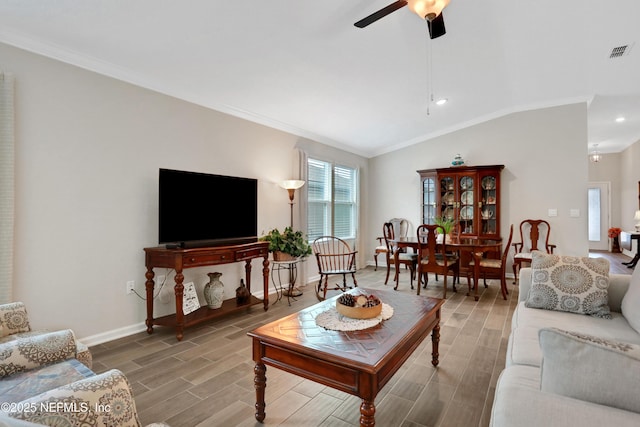 living room featuring lofted ceiling, crown molding, and ceiling fan