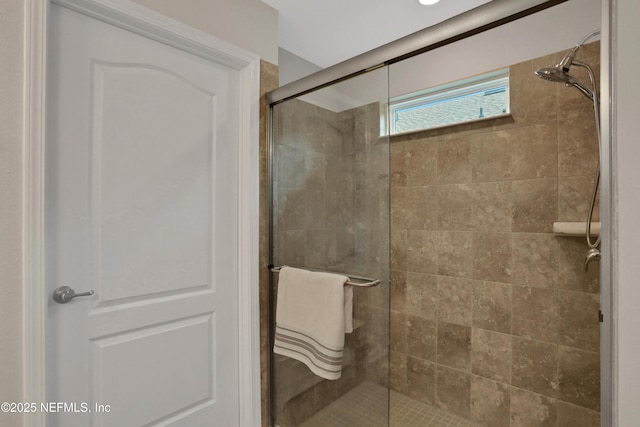 bathroom with a shower with door