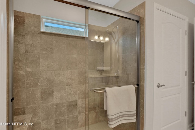 bathroom featuring a shower with shower door