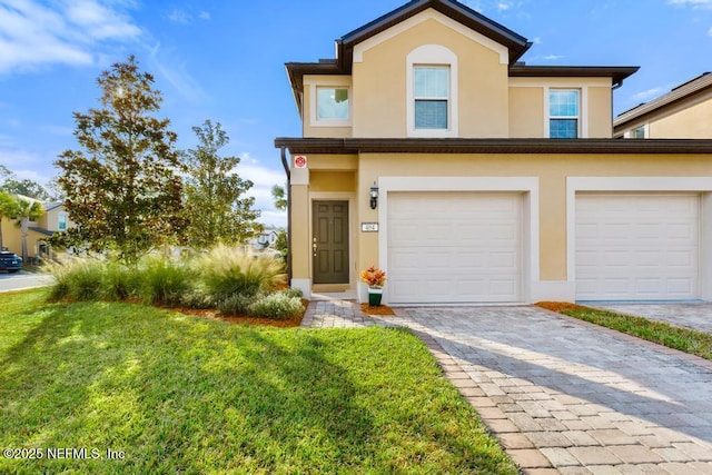 view of front of property with a front yard and a garage