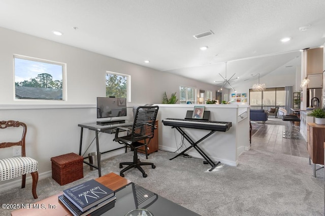 home office featuring light colored carpet, a healthy amount of sunlight, lofted ceiling, and an inviting chandelier