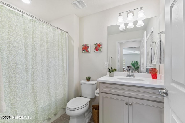 bathroom featuring toilet and vanity