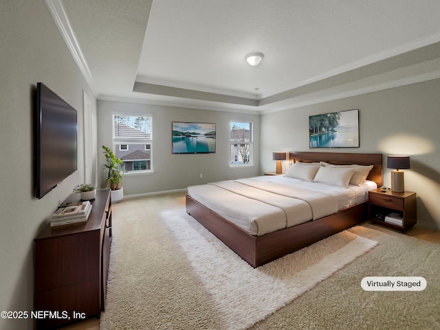 bedroom featuring light carpet, ornamental molding, and a tray ceiling