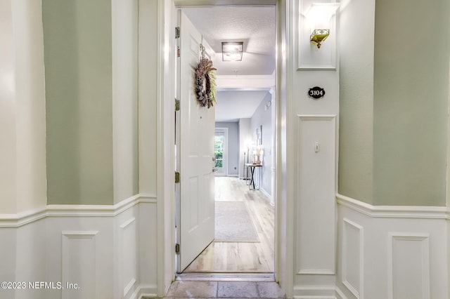 hall with a textured ceiling