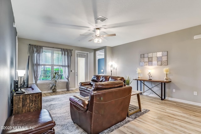 living room featuring light hardwood / wood-style floors and ceiling fan