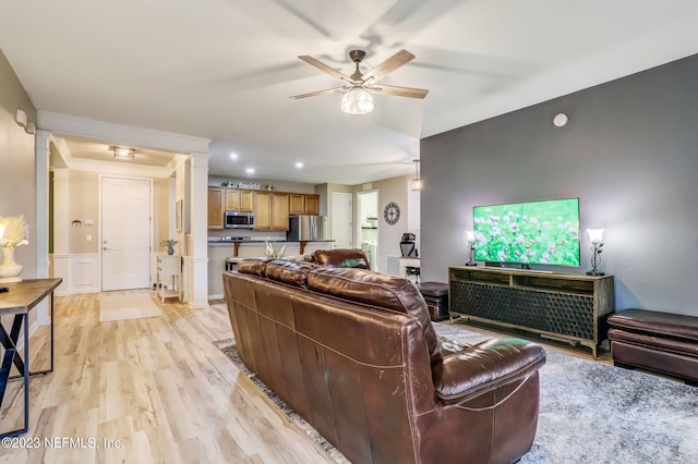 living room with ceiling fan and light hardwood / wood-style floors