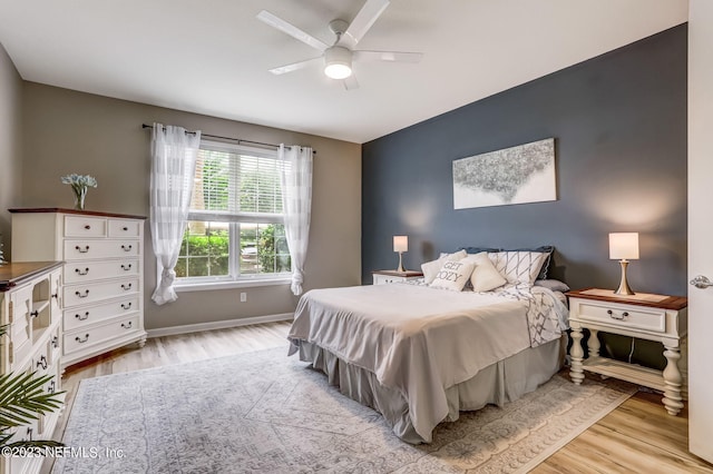 bedroom with ceiling fan and light hardwood / wood-style flooring