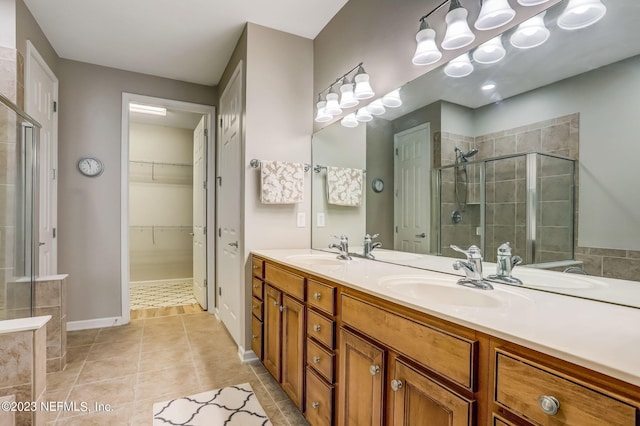 bathroom featuring an enclosed shower, vanity, and tile patterned floors