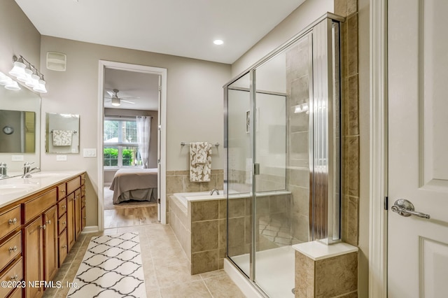 bathroom featuring plus walk in shower, ceiling fan, tile patterned flooring, and vanity