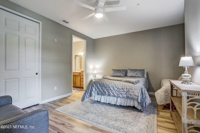 bedroom with ceiling fan, connected bathroom, and light hardwood / wood-style flooring