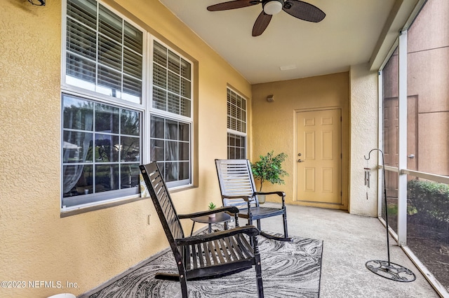 sunroom featuring ceiling fan