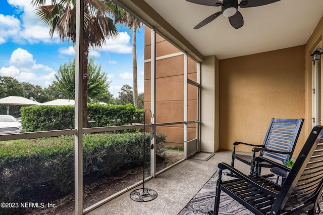 sunroom featuring ceiling fan