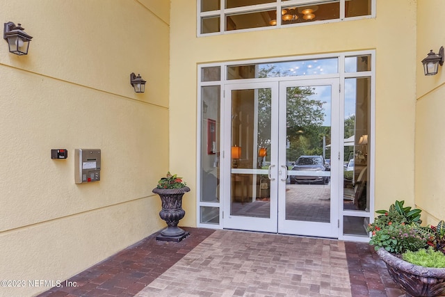 entrance to property featuring french doors and a patio area