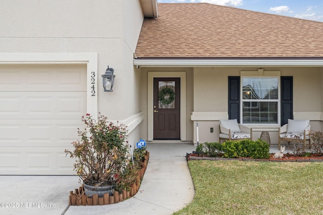 property entrance featuring a lawn and a garage