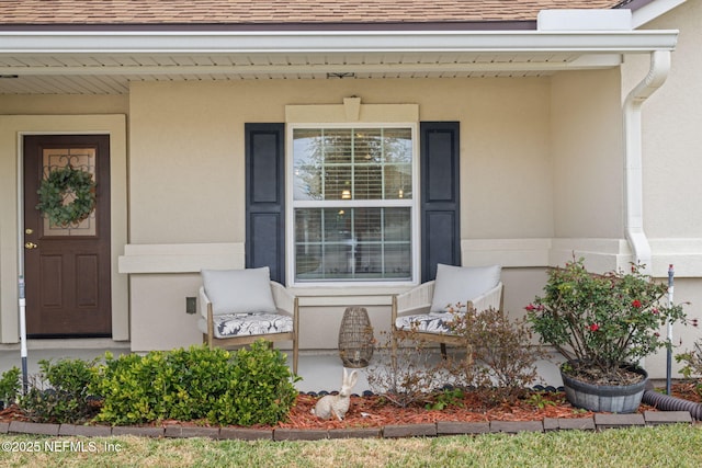 view of exterior entry with a porch