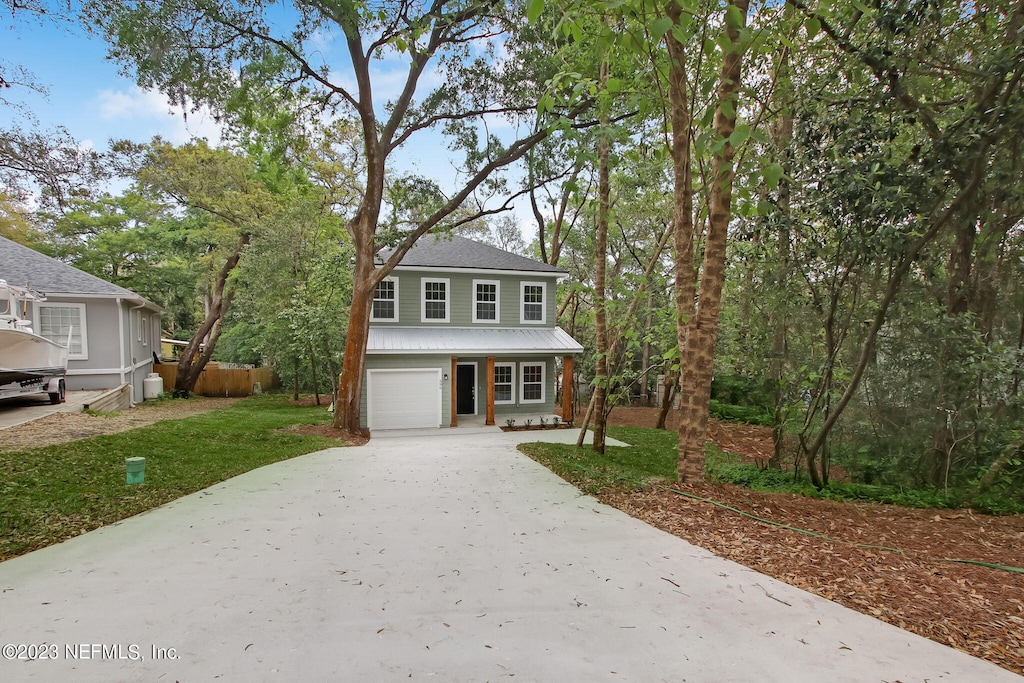 view of front facade with a front yard and a garage