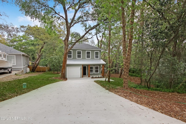 view of front facade with a front yard and a garage