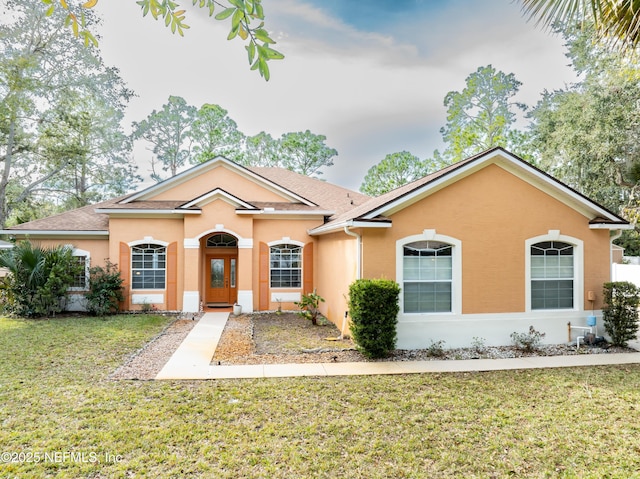 ranch-style home with a front lawn