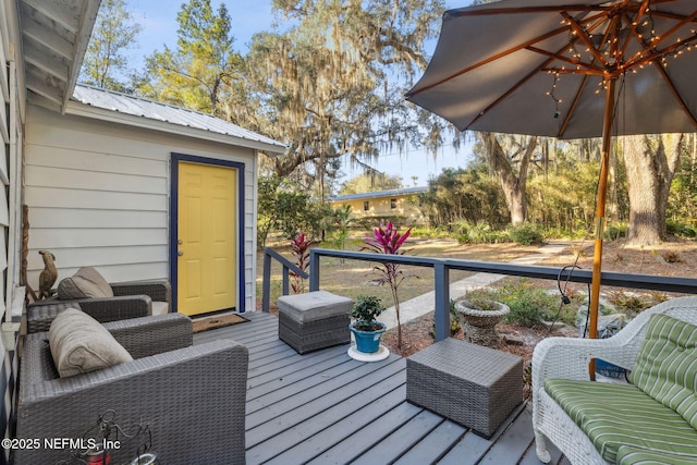 wooden terrace featuring outdoor lounge area