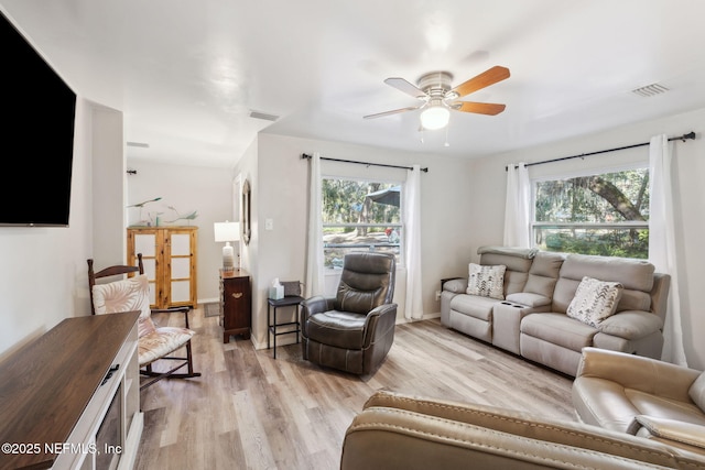 living room with ceiling fan and light hardwood / wood-style floors