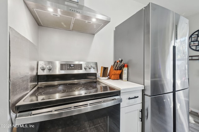 kitchen featuring stainless steel appliances, white cabinetry, and wall chimney exhaust hood