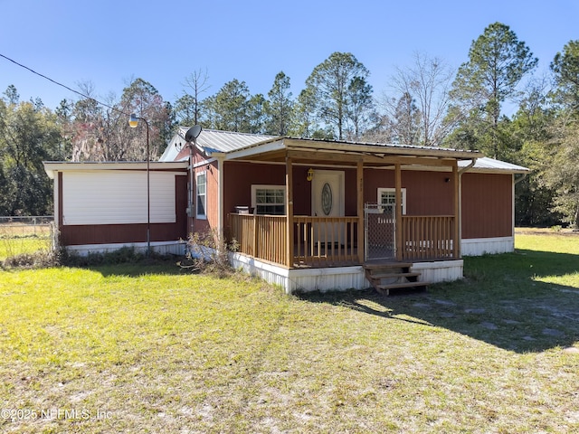 view of front facade with a front yard and covered porch