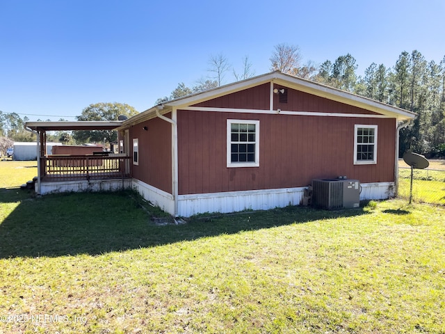 view of property exterior featuring a yard, a deck, and cooling unit