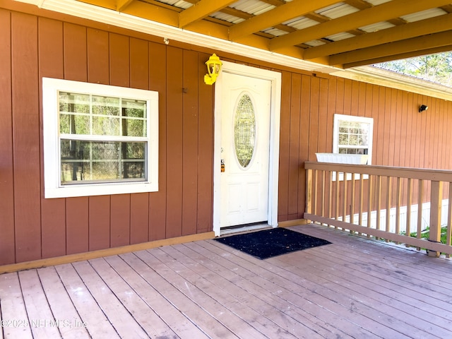 view of exterior entry with a deck