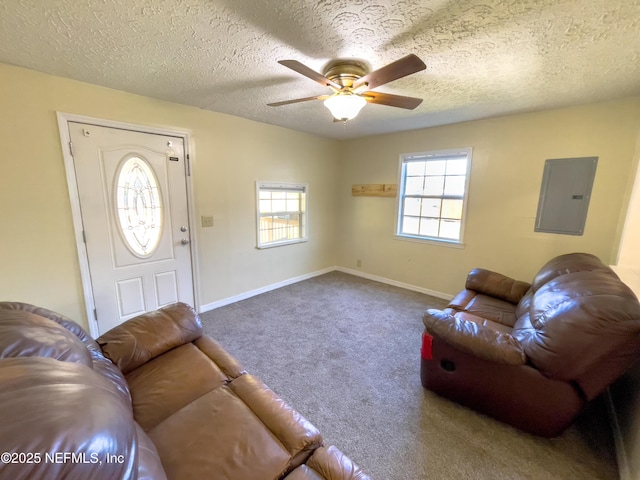 living room featuring electric panel, a textured ceiling, ceiling fan, and carpet flooring