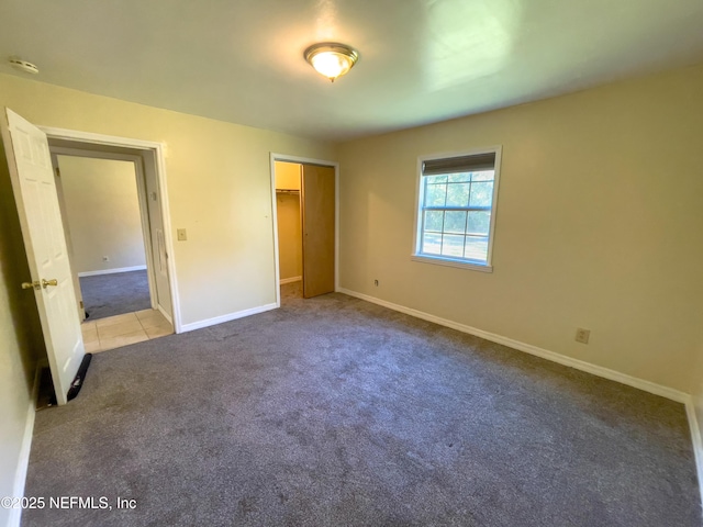 unfurnished bedroom featuring a closet and carpet floors