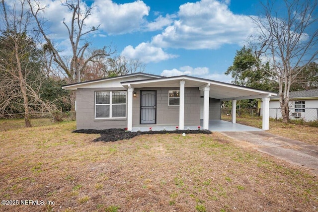 view of front of house featuring a front lawn and a carport