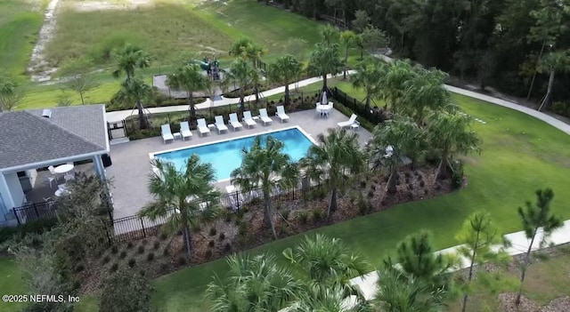 view of pool featuring a lawn and a patio