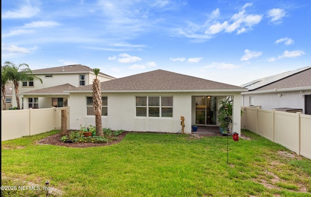 rear view of house with a yard