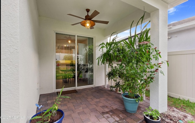 entrance to property featuring ceiling fan and a patio area