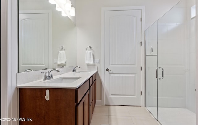 bathroom with tile patterned flooring, a shower with door, and vanity